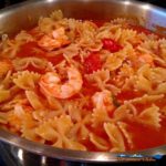 Basil, garlic, broth and tomato sauce all come together to create a delicious light sauce over Farfalle noodles and plump shrimp for this Shrimp Pomodoro. | TheMountainKitchen.com