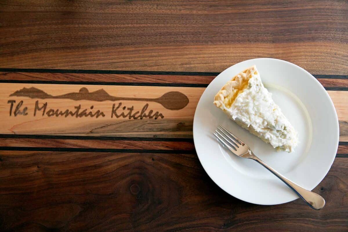slice of coconut cream pie on plate with fork