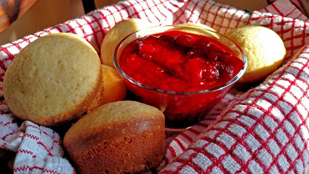 Strawberry Shortcake Surprise is made with light fluffy shortcake cupcakes covered in thick syrupy strawberry compote, fresh strawberries and whipped cream. | TheMountainKitchen.com