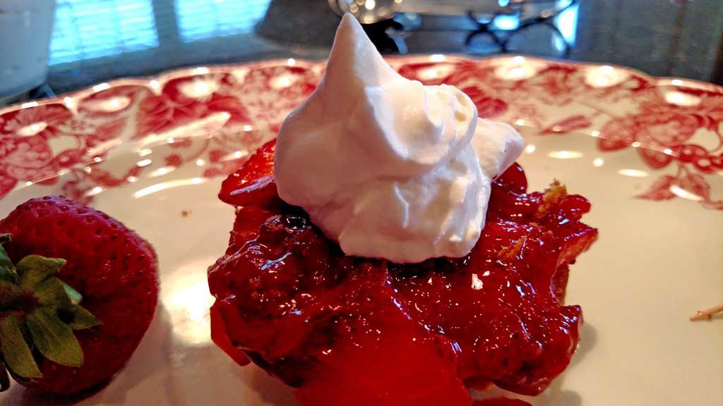 Strawberry Shortcake Surprise is made with light fluffy shortcake cupcakes covered in thick syrupy strawberry compote, fresh strawberries and whipped cream. | TheMountainKitchen.com
