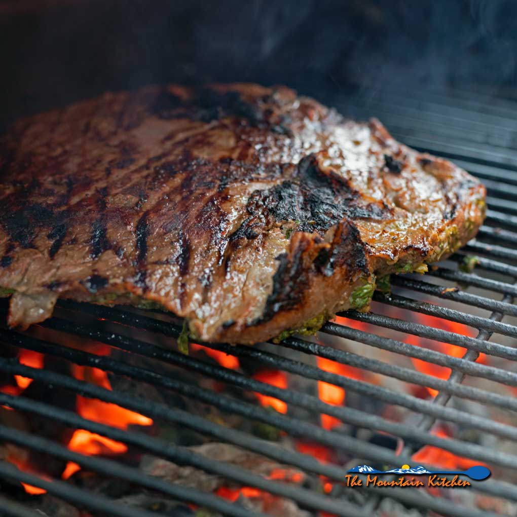 carne asada cooking on grill