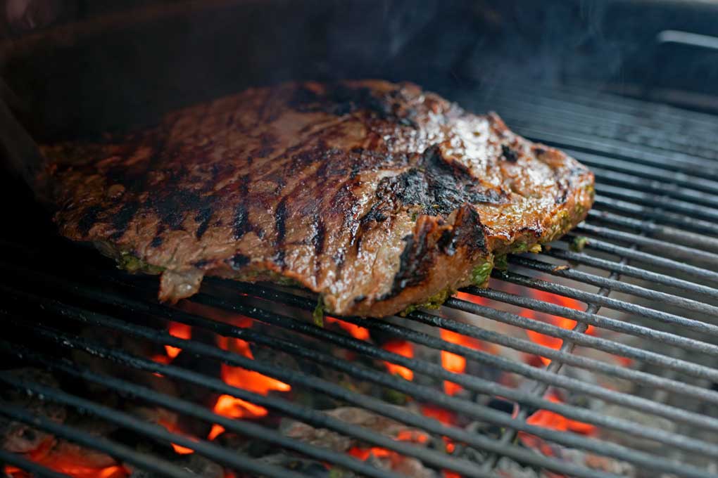 carne asada cooking on grill