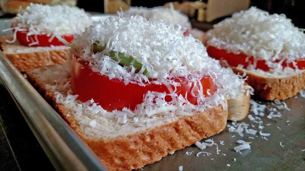 cheese piled up on to of the caprese sandwiches