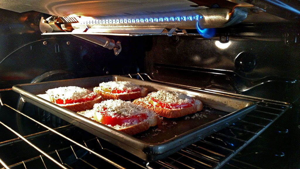 open-face caprese sandwiches baking in the oven