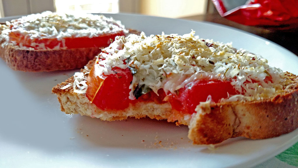 This open-face Caprese Sandwich is perfect for a quick summer meal, toasted bread with tomato slices, basil, mozzarella and parmesan cheese.