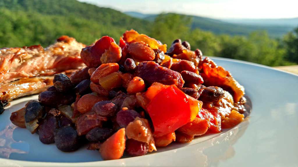 Smoky Pineapple Baked Beans with bacon and chipotle chile pepper, pineapple, red pepper, with hints of barbecue sauce and beer that round out the flavors. | TheMountainKitchen.com