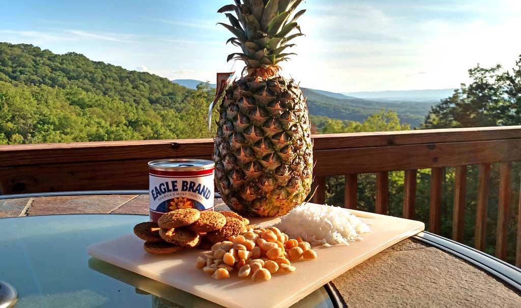 This stuffed pineapple is a tropical paradise,. Juicy pineapple baked and caramelized with a coconut, ginger snap topping. | TheMountainKitchen.com