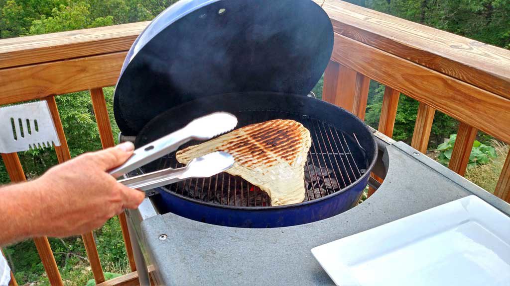 Triangle shaped pizza crust with char-markings.