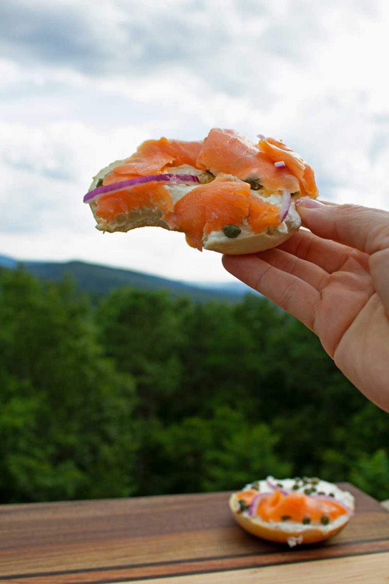 hand holding bitten lox bagel