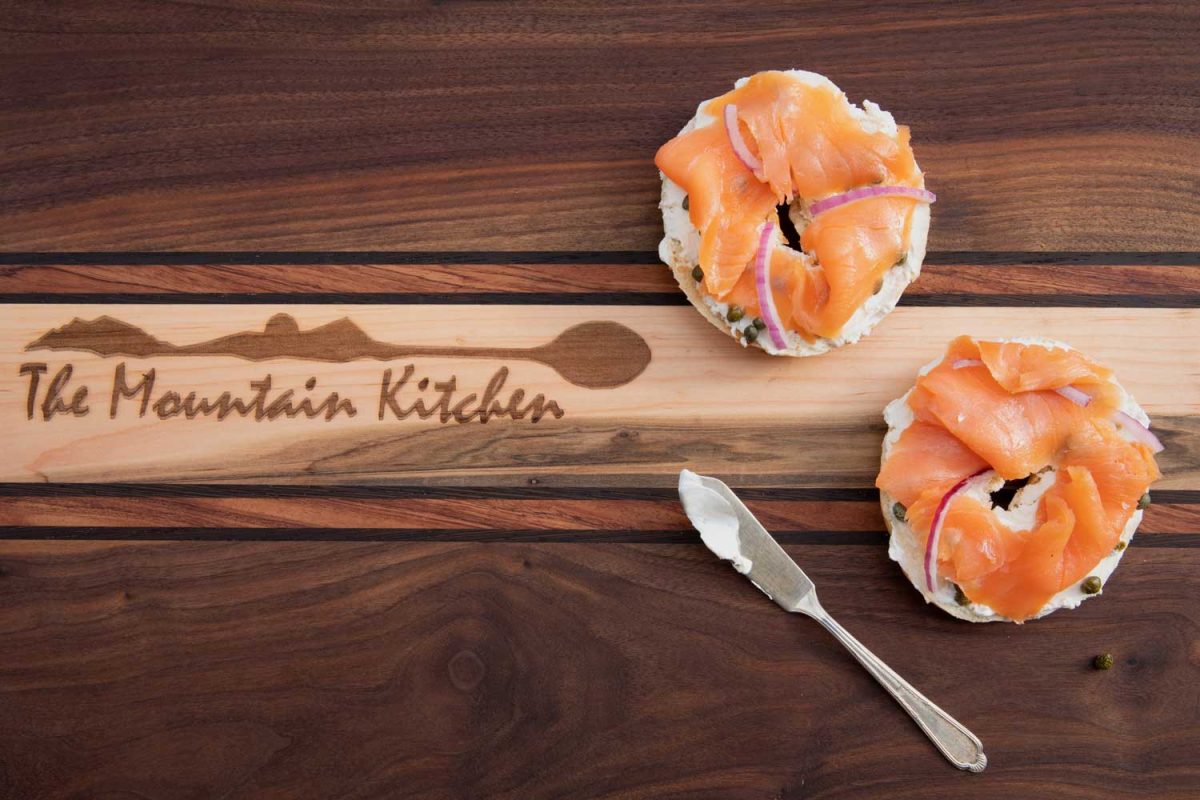 bagels on board with knife with cream cheese