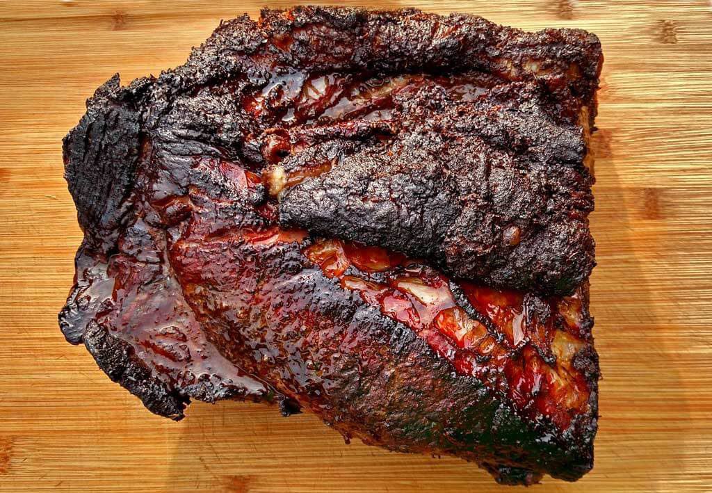 juicy smoked beef brisket on cutting board