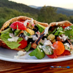 Greek pita sandwiches on plate with mountain view