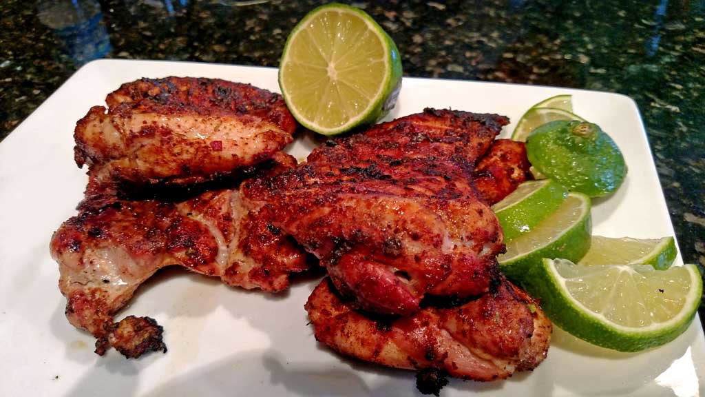 These delicious grilled chicken fajitas are a breeze to make with grilled chicken thighs with Mexican spices served with grilled vegetables on a tortilla. | TheMountainKitchen.com