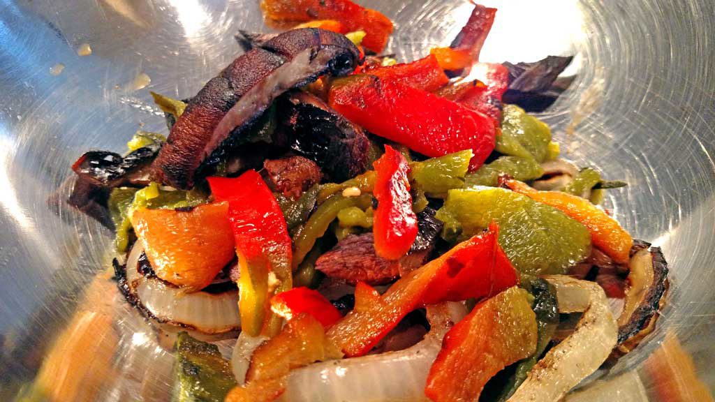 These delicious grilled chicken fajitas are a breeze to make with grilled chicken thighs with Mexican spices served with grilled vegetables on a tortilla. | TheMountainKitchen.com
