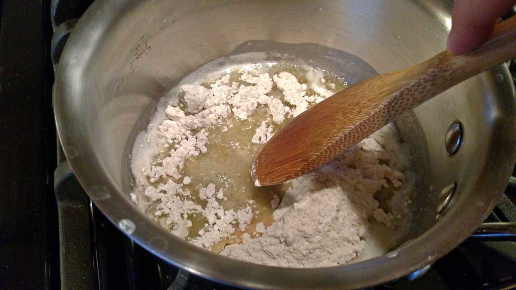 stirring flour into melted butter in the pot