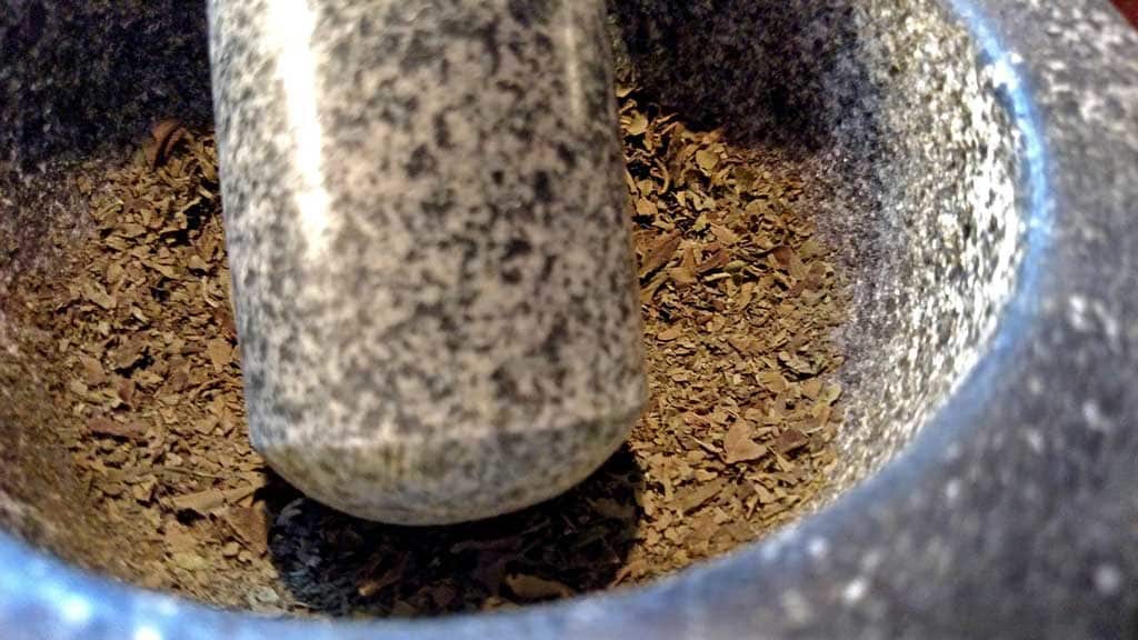 ground basil leaves in mortar