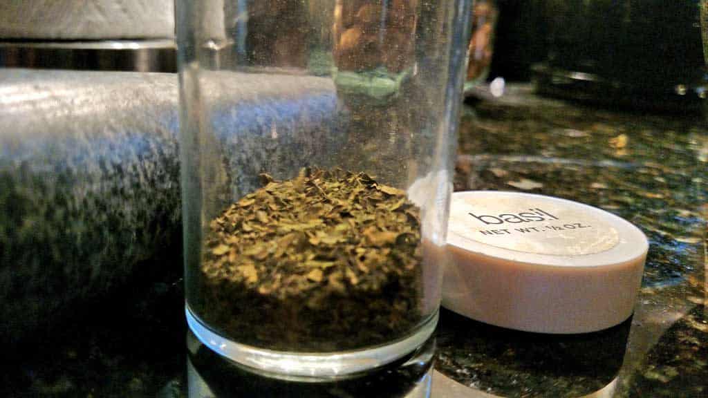 ground basil in spice jar