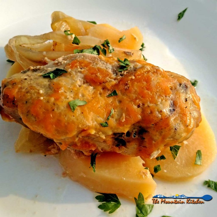 You will love this crock-pot pork chop casserole. Delicious pork chops slow-cooked in a creamy sauce with potatoes, onion and cheese. | TheMountainKitchen.com