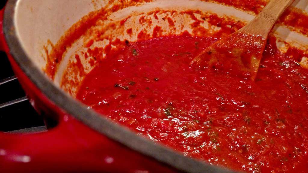 This homemade tomato sauce is made with San Marzano tomatoes, a hearty red wine, and lots of fresh summer basil; the beginning of countless Italian dishes. | TheMountainKitchen.com