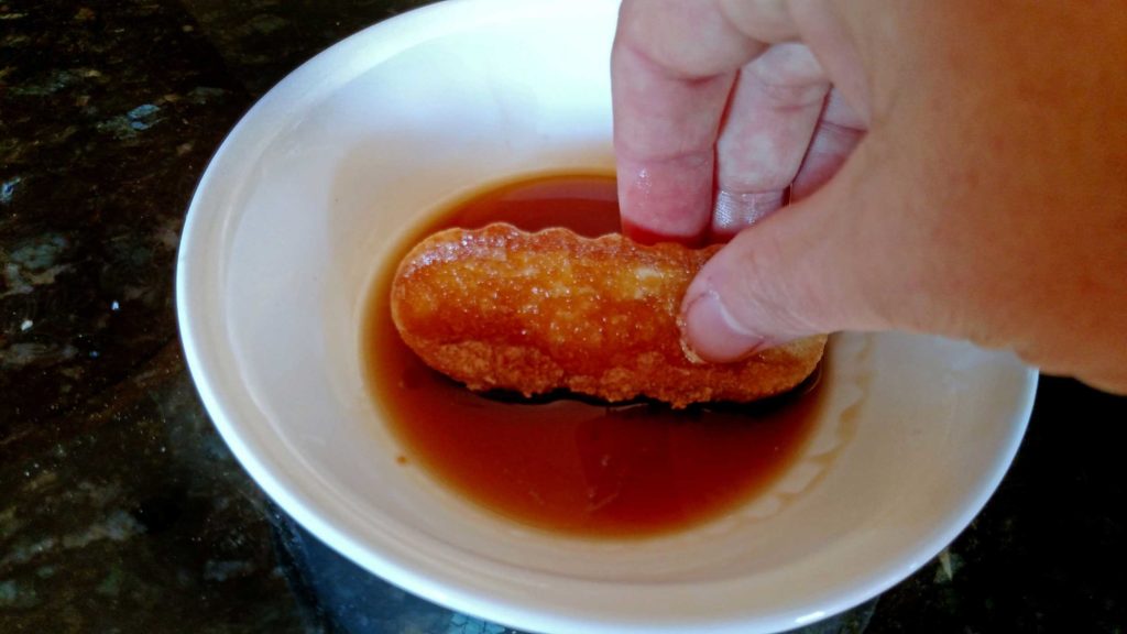 dipping lady finger into coffee liqueur