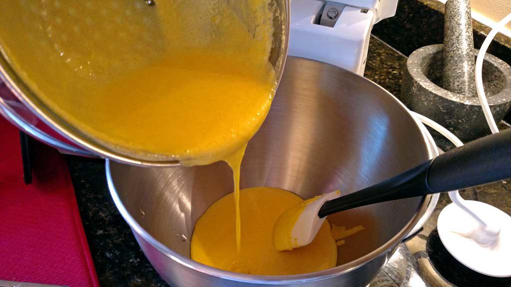 pouring yolk mixture into mixing bowl