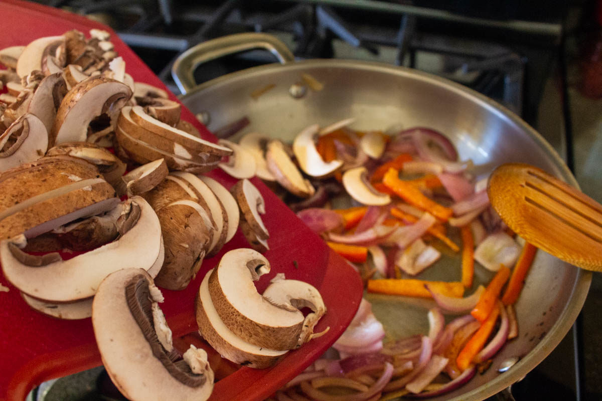 adding mushrooms to the pan