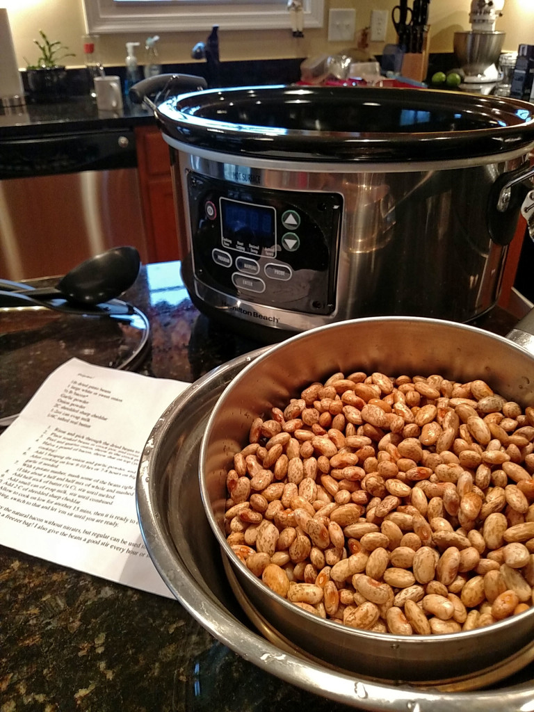 crock-pot with drained dried pinto beans in bowl