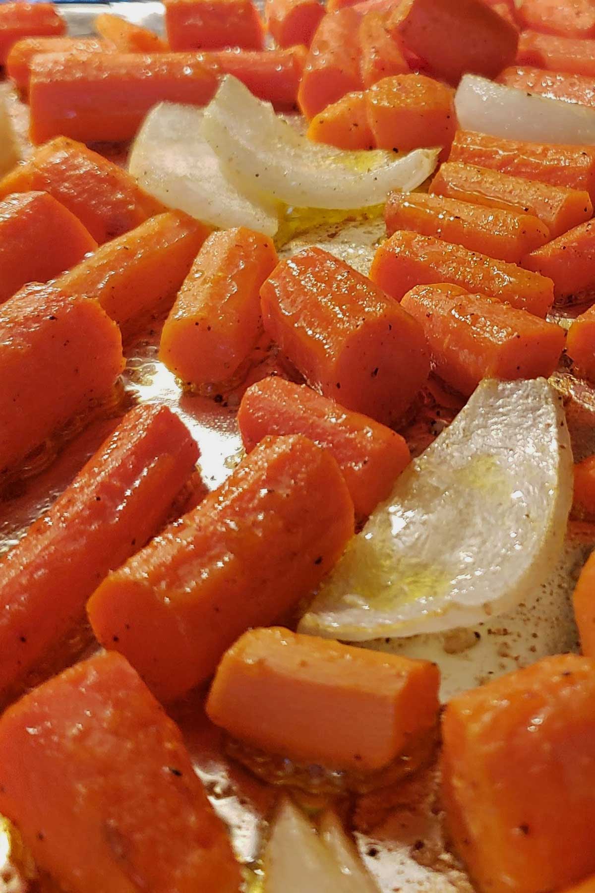 carrots, onions and garlic roasting on a backing sheet