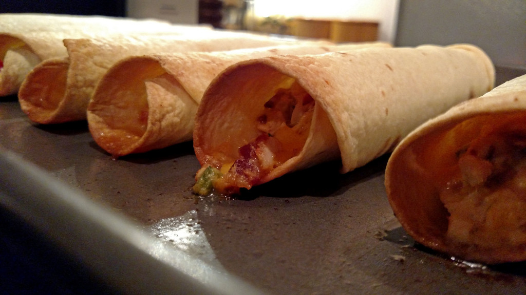 crispy taquitos on baking sheet