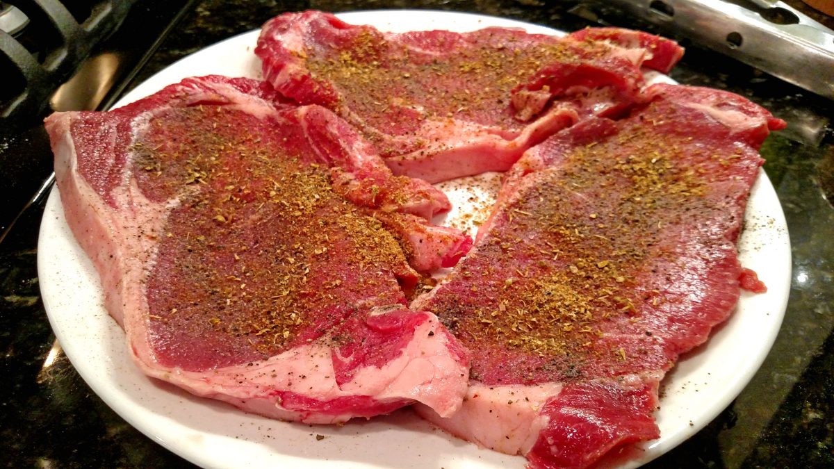 seasoned steaks on plate