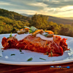 Steak and Refried Bean Enchilada on plate with mountain view