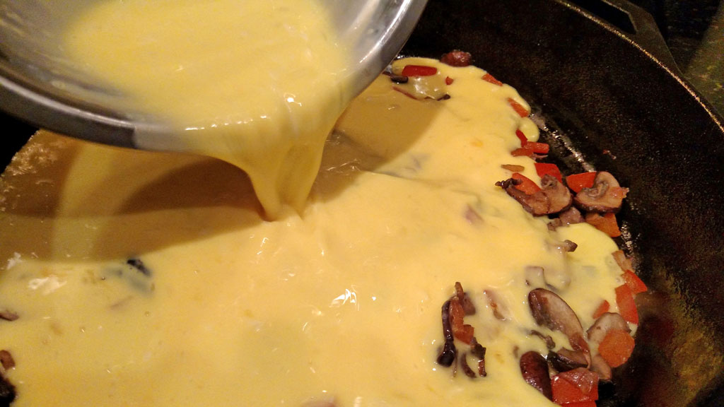 pouring egg mixture into pan