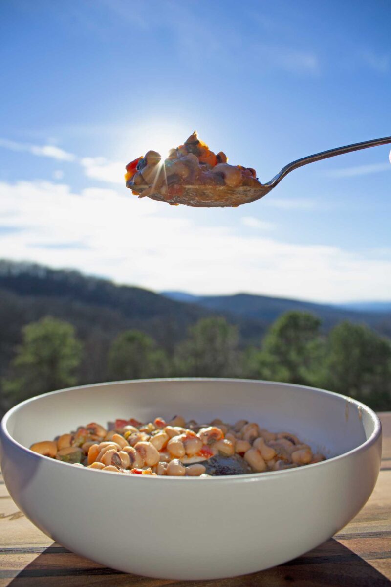 bowl of hoppin john with spoonful overtop