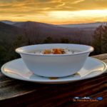 bowl of crock-pot potato leek soup with mountain view