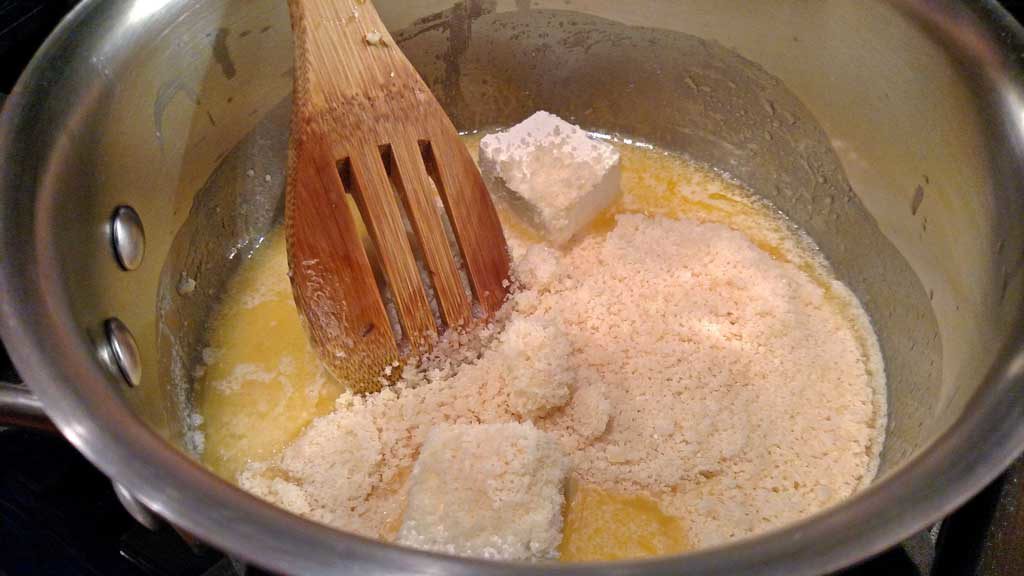 stirring cheese and butter into pan