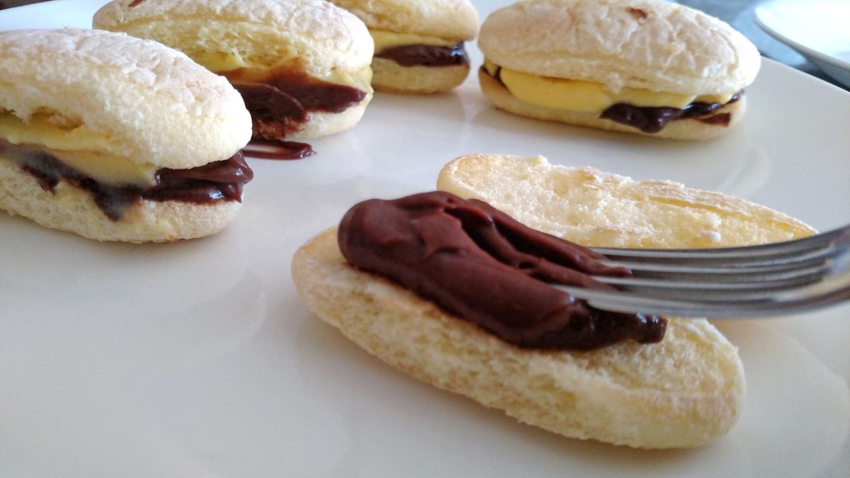 smearing chocolate onto ladyfinger