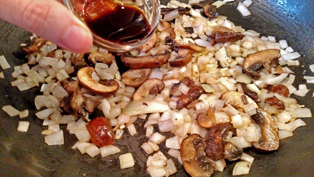 pouring Worcestershire sauce into pan