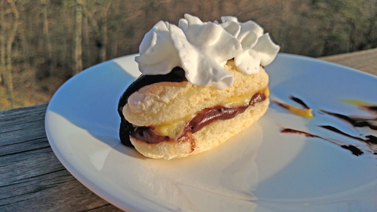 whipped cream topped ladyfinger eclair