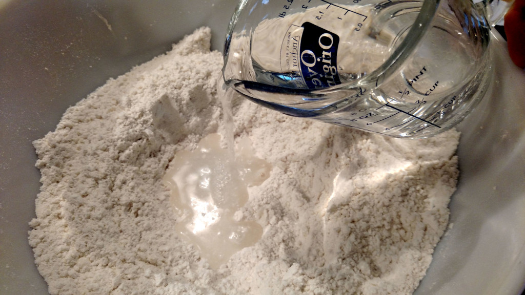 pouring water into flour