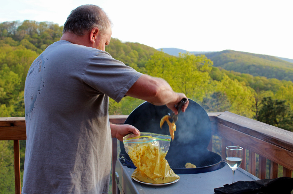 David putting chicken on the grill