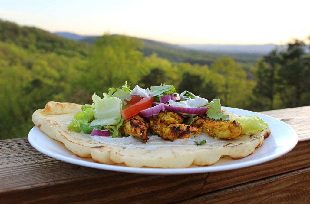 grilled tandoori chicken on naan bread with mountain view