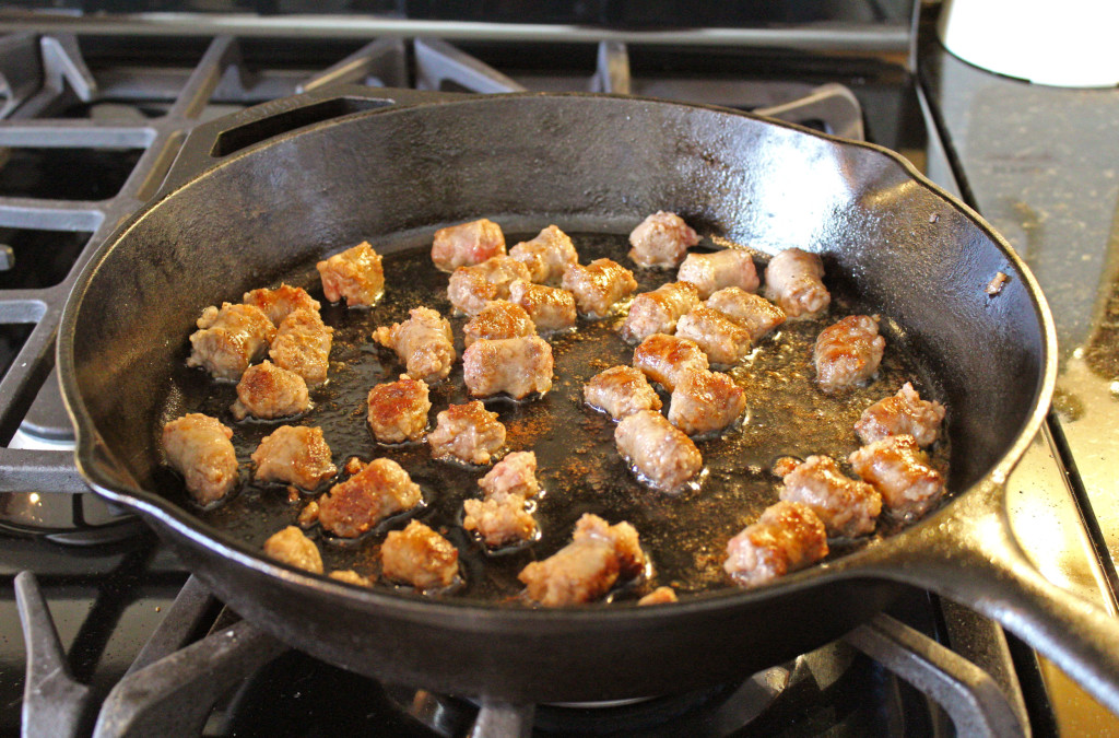 Camper's breakfast hash sausage browning in cast iron pan