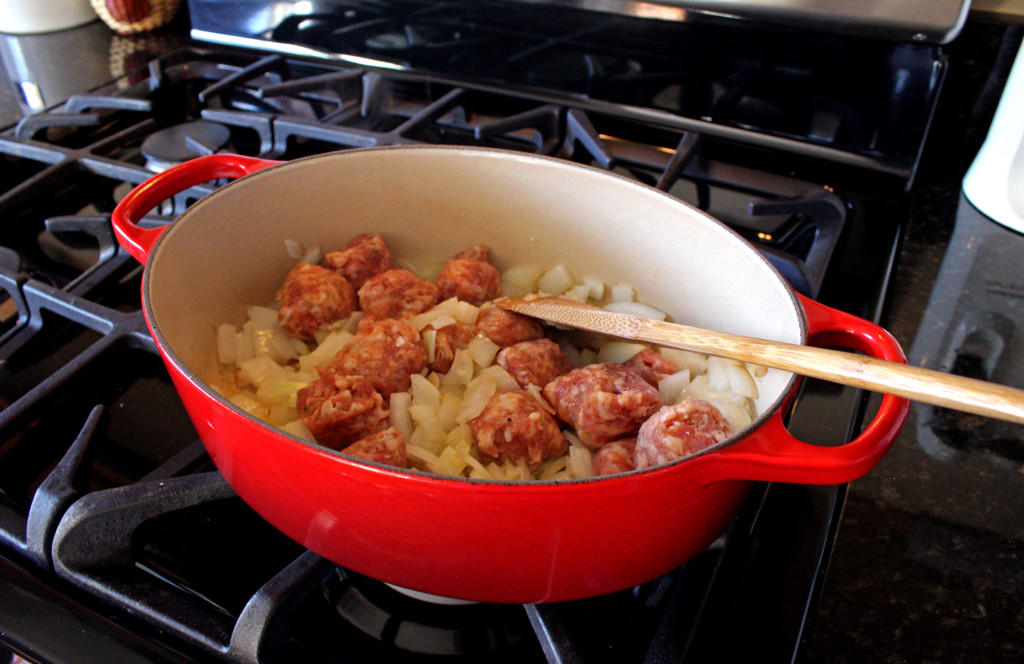 Italian sausage and onions cooking in pot