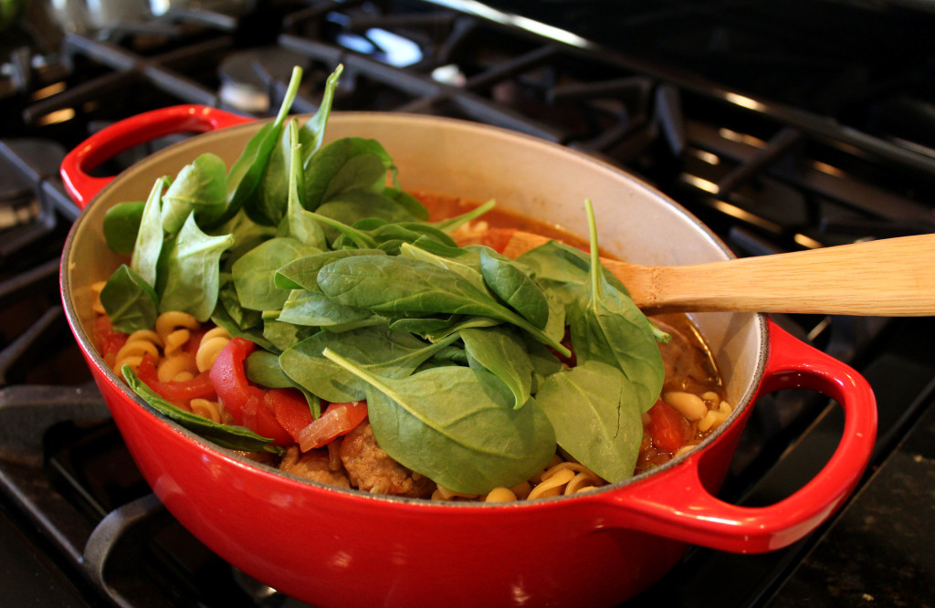 spinach added to the soup on stove