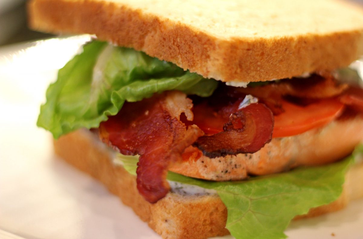 salmon blt with bacon hanging out