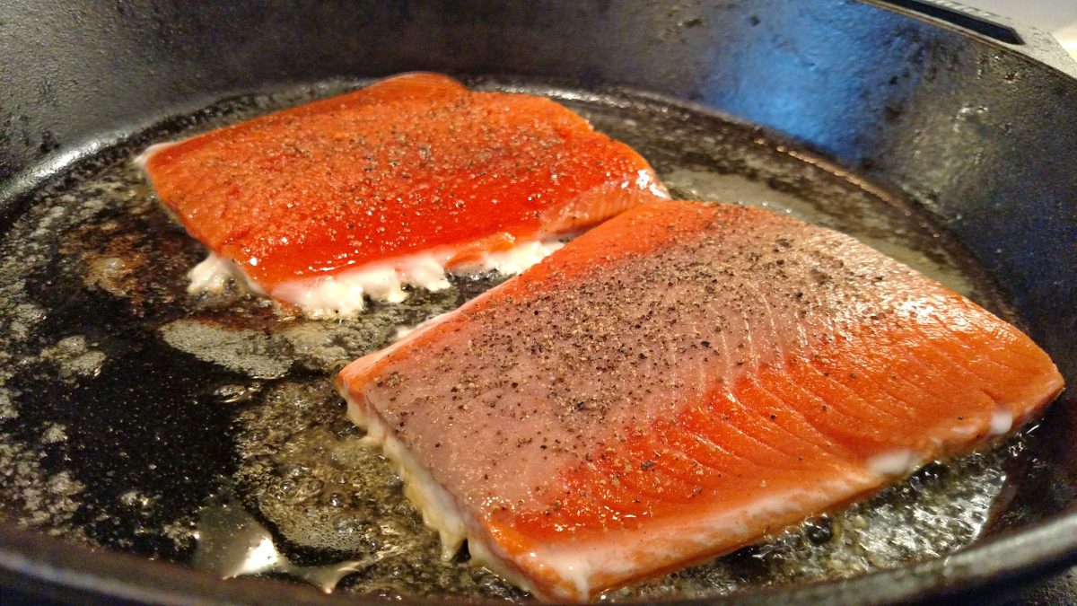 salmon cooking in pan