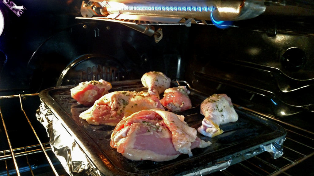 chicken on broiler pan under boiler in oven