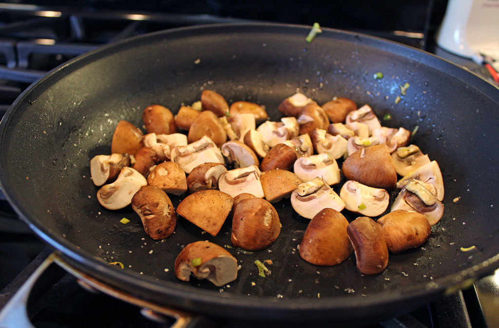 mushrooms cooking in skillet