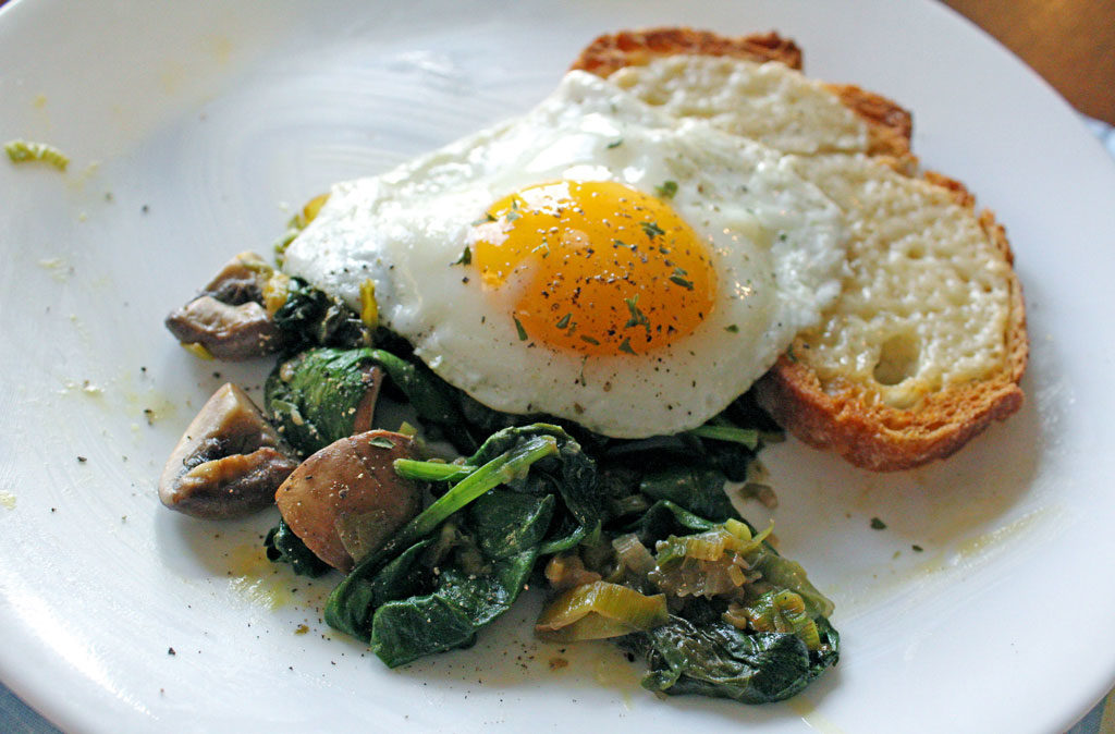 Leeks and Mushrooms With Cheesy Toasts and Fried Eggs on a plate
