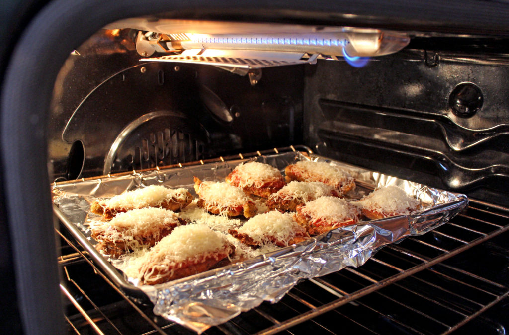 chicken baking in oven under broiler